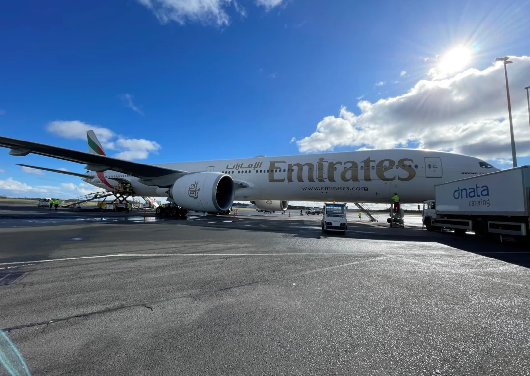 An Emirates Boeing 777 on an airport tarmac.