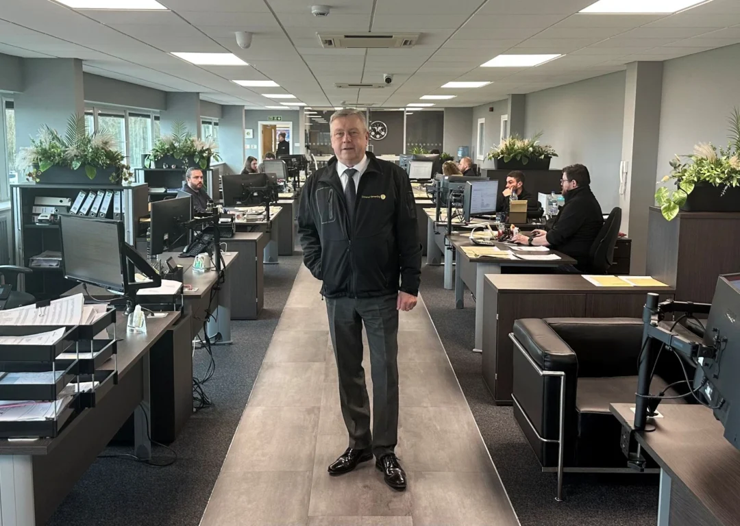 Trevor Harbottle, Managing Director of Universal Forwarding standing in the company office.